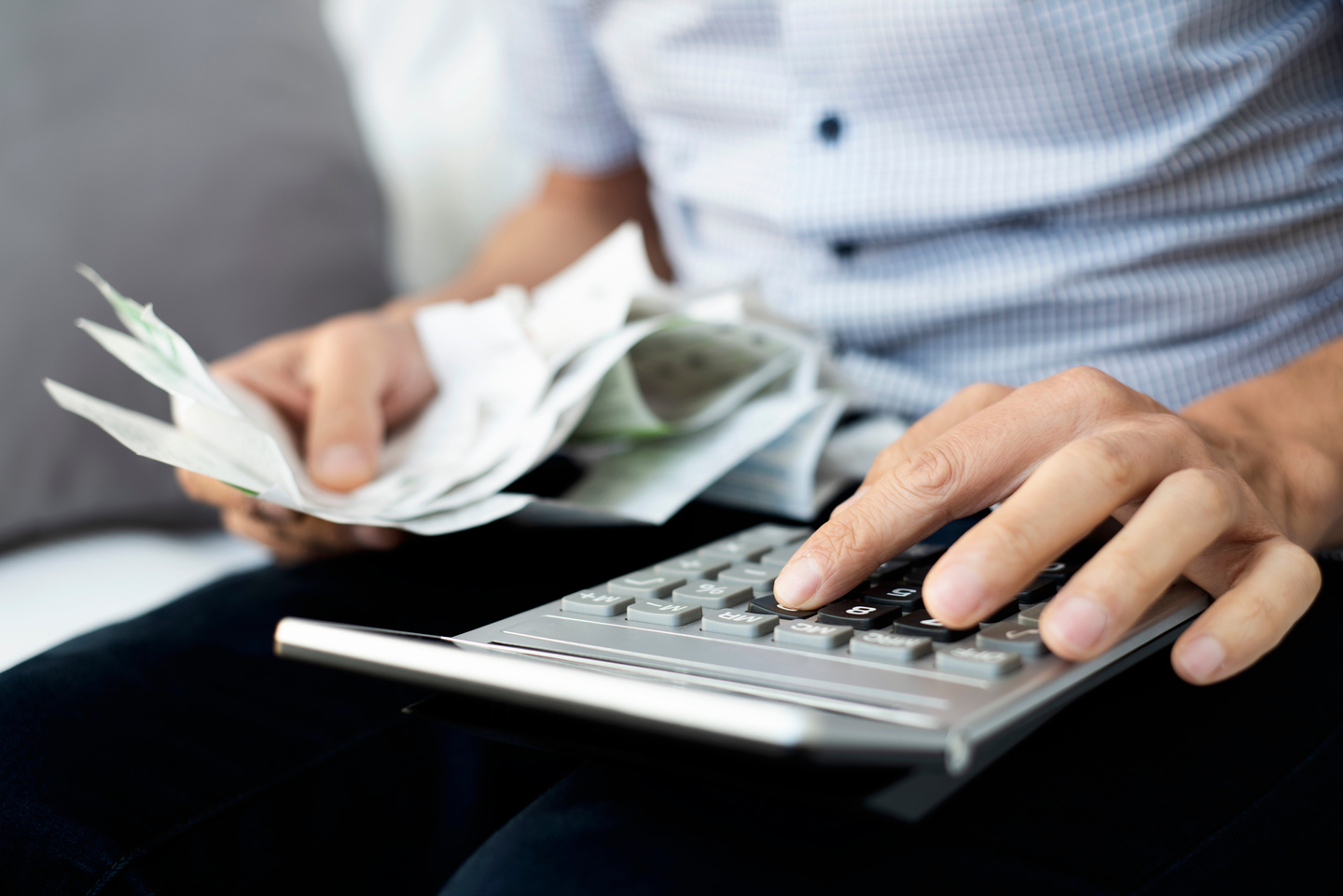 Young Man with Bills and Calculator